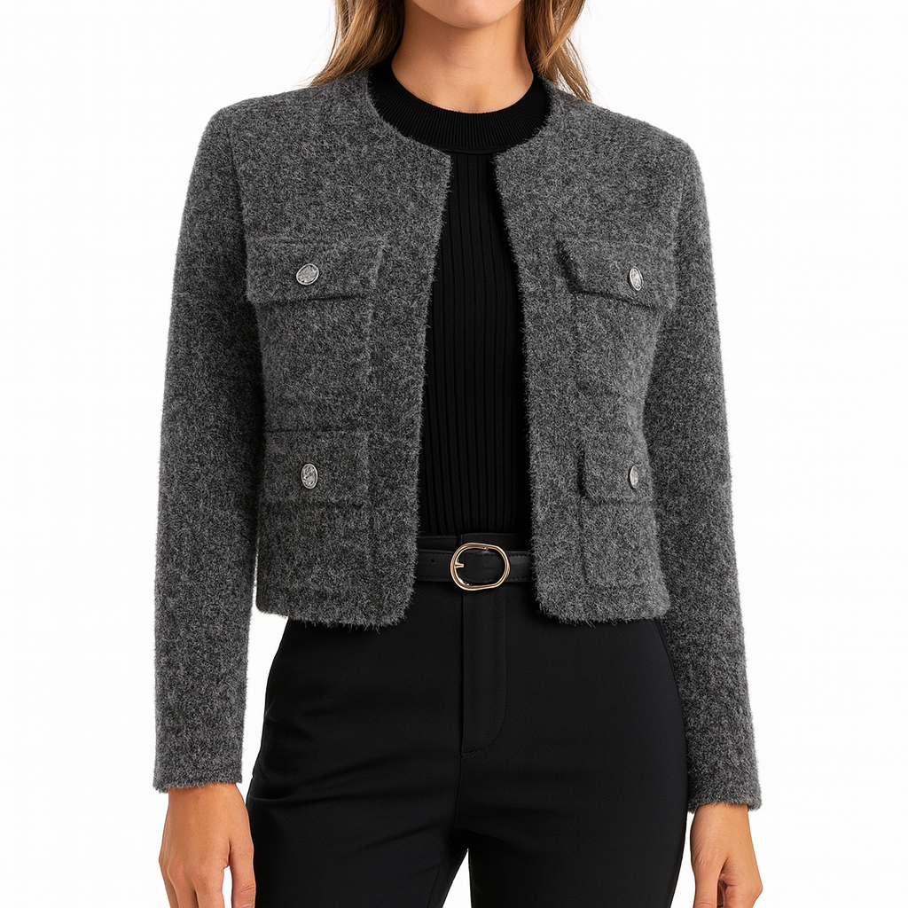Cropped jacket with a stand collar, front zip closure, two flap chest pockets with button details, and long sleeves.