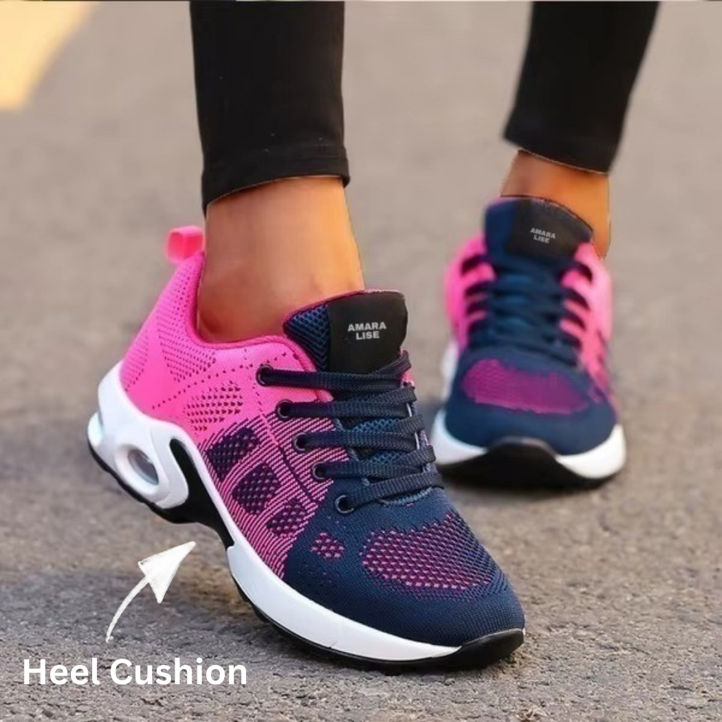 Women’s navy and pink lightweight mesh trainers with air cushion heel and lace-up design, styled with black leggings.